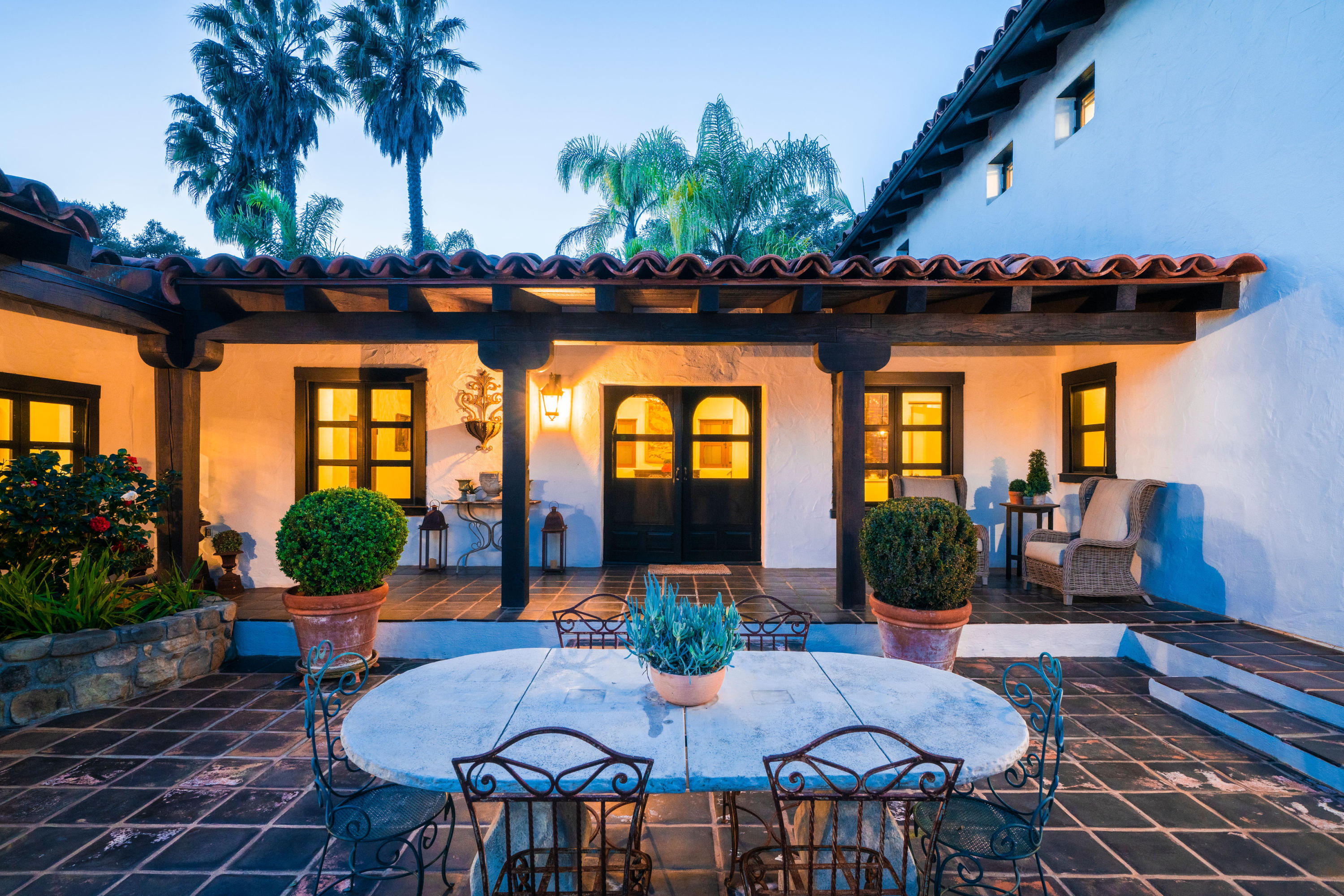 660 El Bosque Road Montecito, CA 93108 - Photo 6 of 34 a view of a patio with table and chairs potted plants and floor to ceiling window and potted plants