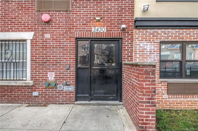 a buildings with car parked in front of it