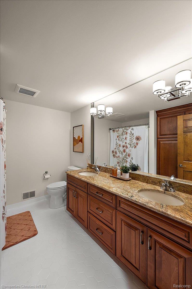 1071 Woodbridge Lane Rochester, MI 48306 - Photo 47 of 76 Full bathroom with hanging lights, double vanity, a shower with shower curtain, and light tile patterned flooring