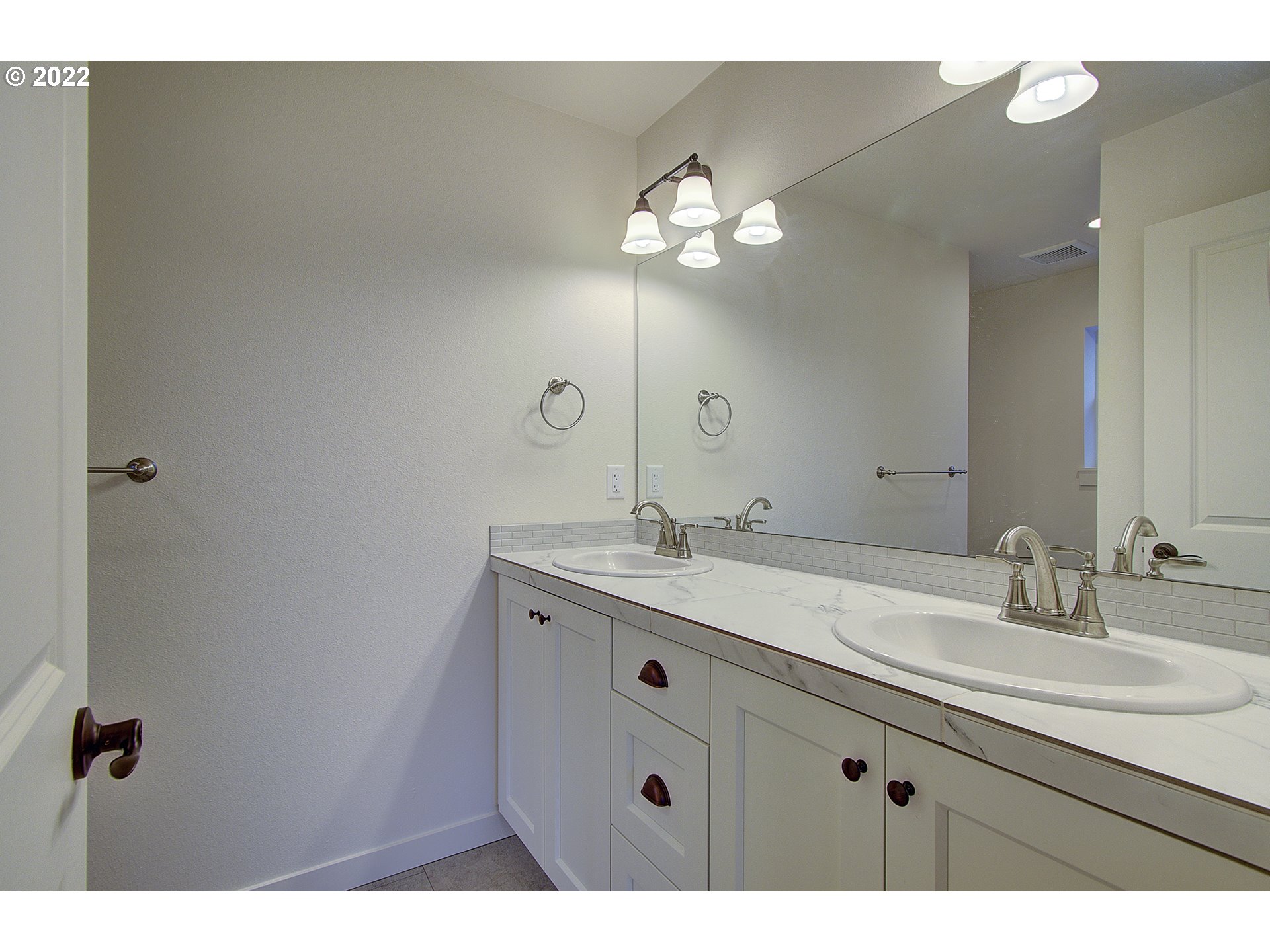 7107 South 11th Street Ridgefield, WA 98642 - Photo 14 of 26 a bathroom with a sink and a mirror