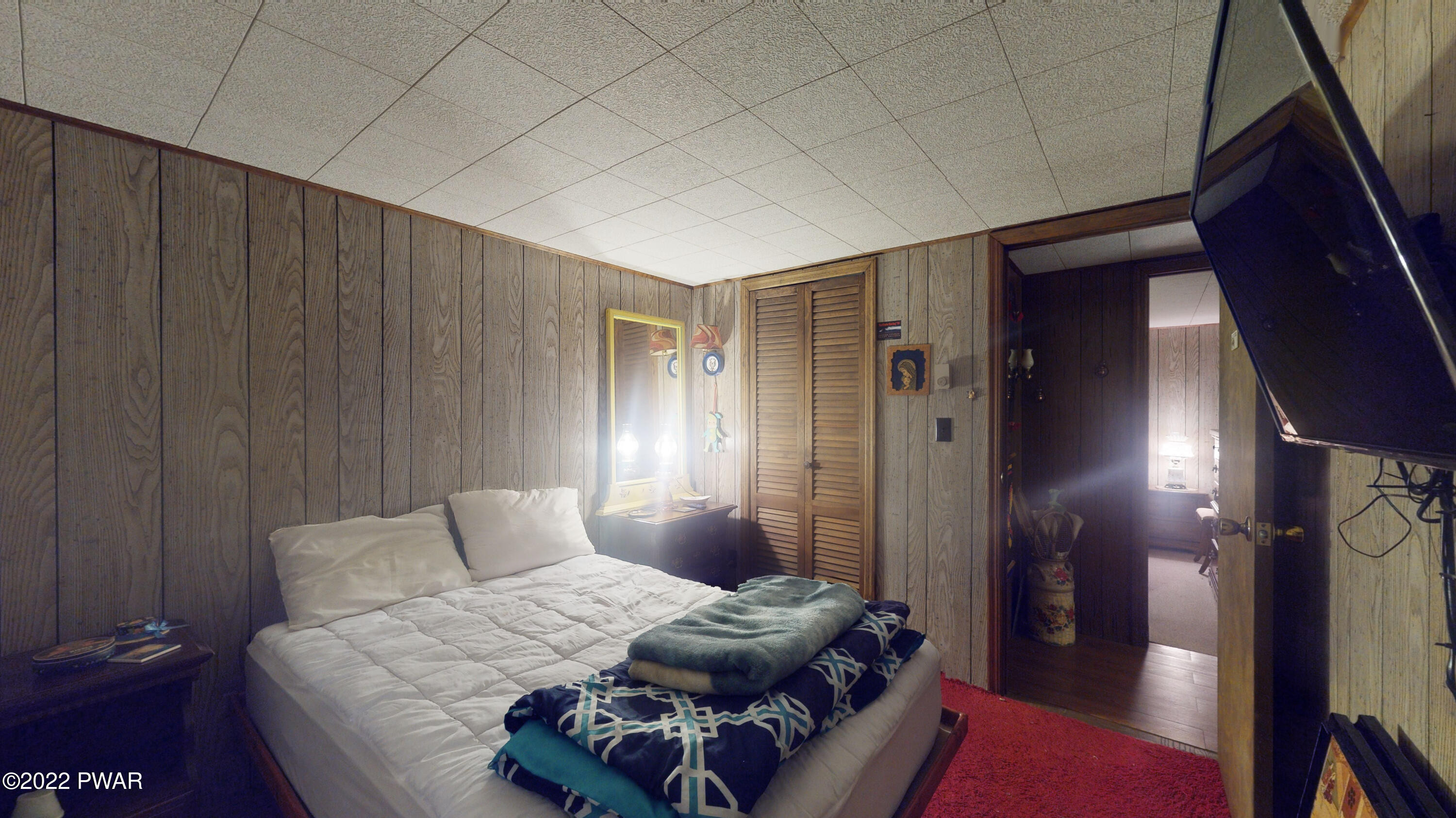 137 Stamford Road Dingmans Ferry, PA 18328 - Photo 27 of 31 a bedroom with furniture and a mirror