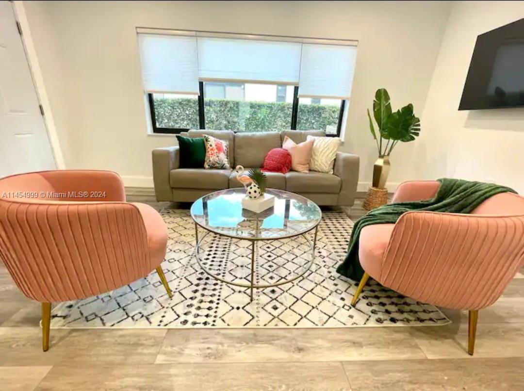 2141 Southwest 14th Terrace Miami, FL 33145 - Photo 13 of 47 a living room with furniture and a floor to ceiling window