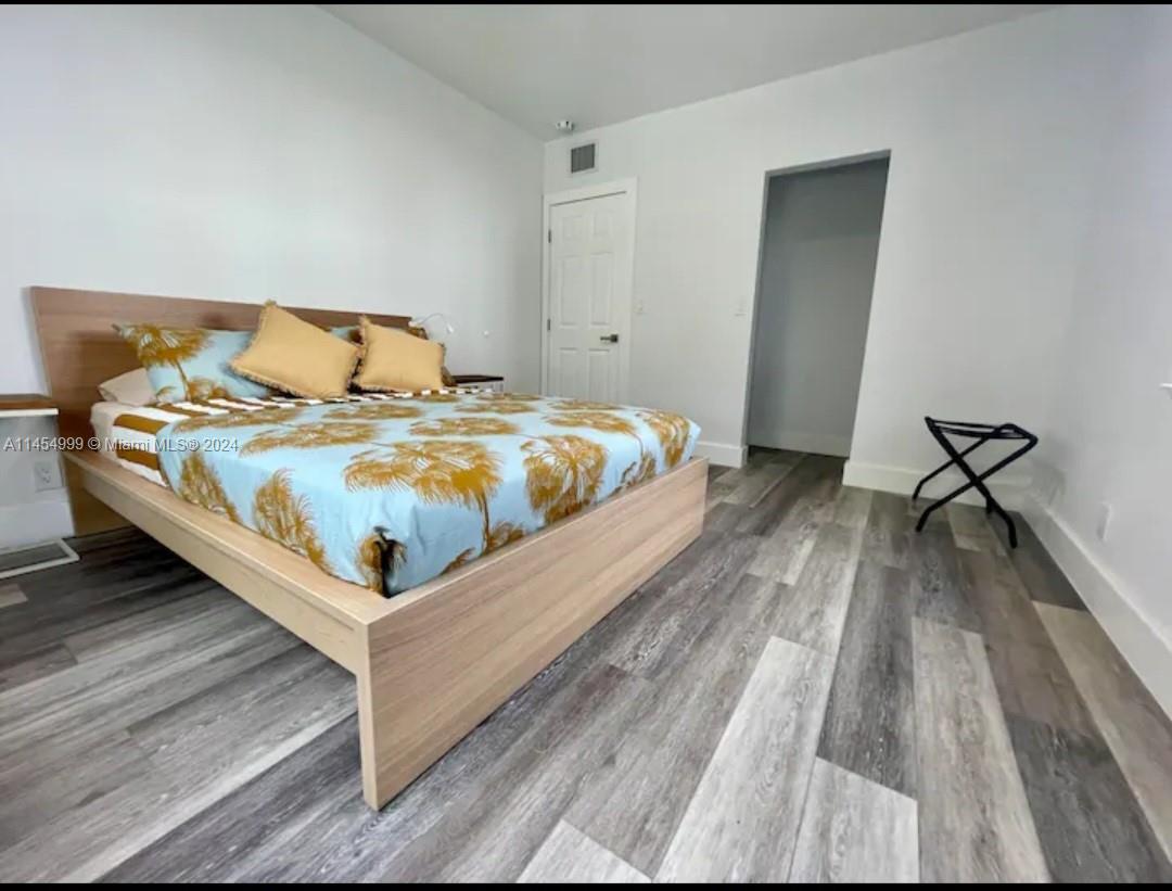 2141 Southwest 14th Terrace Miami, FL 33145 - Photo 15 of 47 a bedroom with a bed and wooden floor