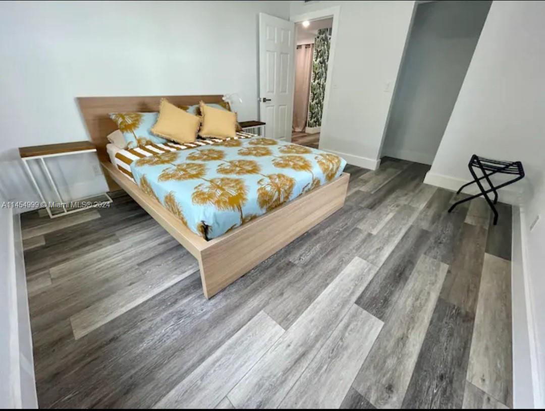 2141 Southwest 14th Terrace Miami, FL 33145 - Photo 16 of 47 a bedroom with a bed and wooden floor