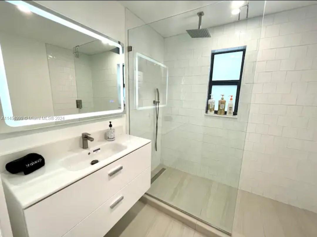 2141 Southwest 14th Terrace Miami, FL 33145 - Photo 18 of 47 a bathroom with a sink mirror and shower