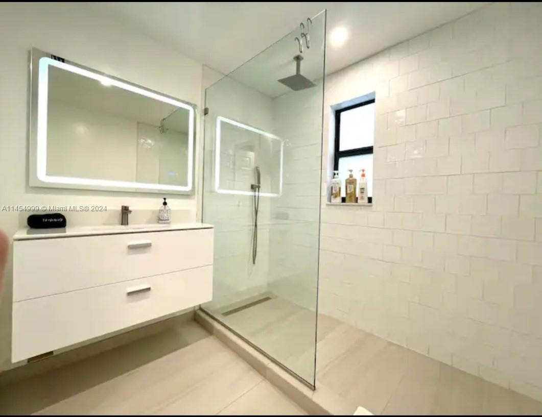2141 Southwest 14th Terrace Miami, FL 33145 - Photo 19 of 47 a bathroom with a sink mirror and shower