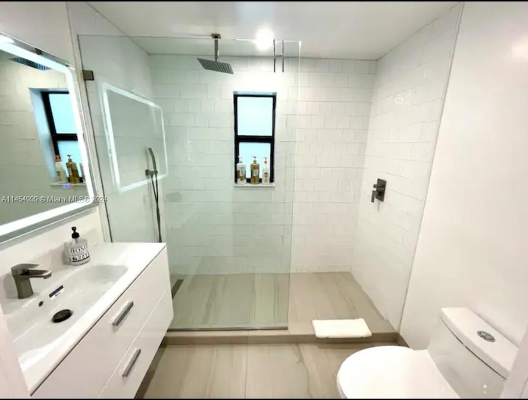 2141 Southwest 14th Terrace Miami, FL 33145 - Photo 20 of 47 a bathroom with a sink mirror vanity and toilet
