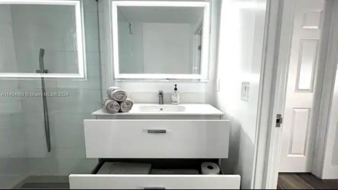 2141 Southwest 14th Terrace Miami, FL 33145 - Photo 23 of 47 a bathroom with a sink and a mirror