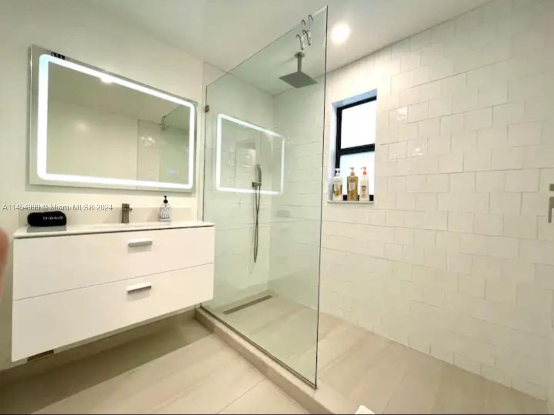 2141 Southwest 14th Terrace Miami, FL 33145 - Photo 25 of 47 a bathroom with a shower sink and mirror