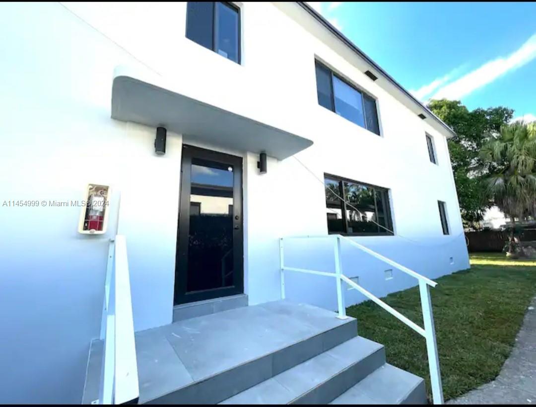 2141 Southwest 14th Terrace Miami, FL 33145 - Photo 3 of 47 a front view of a house with entryway