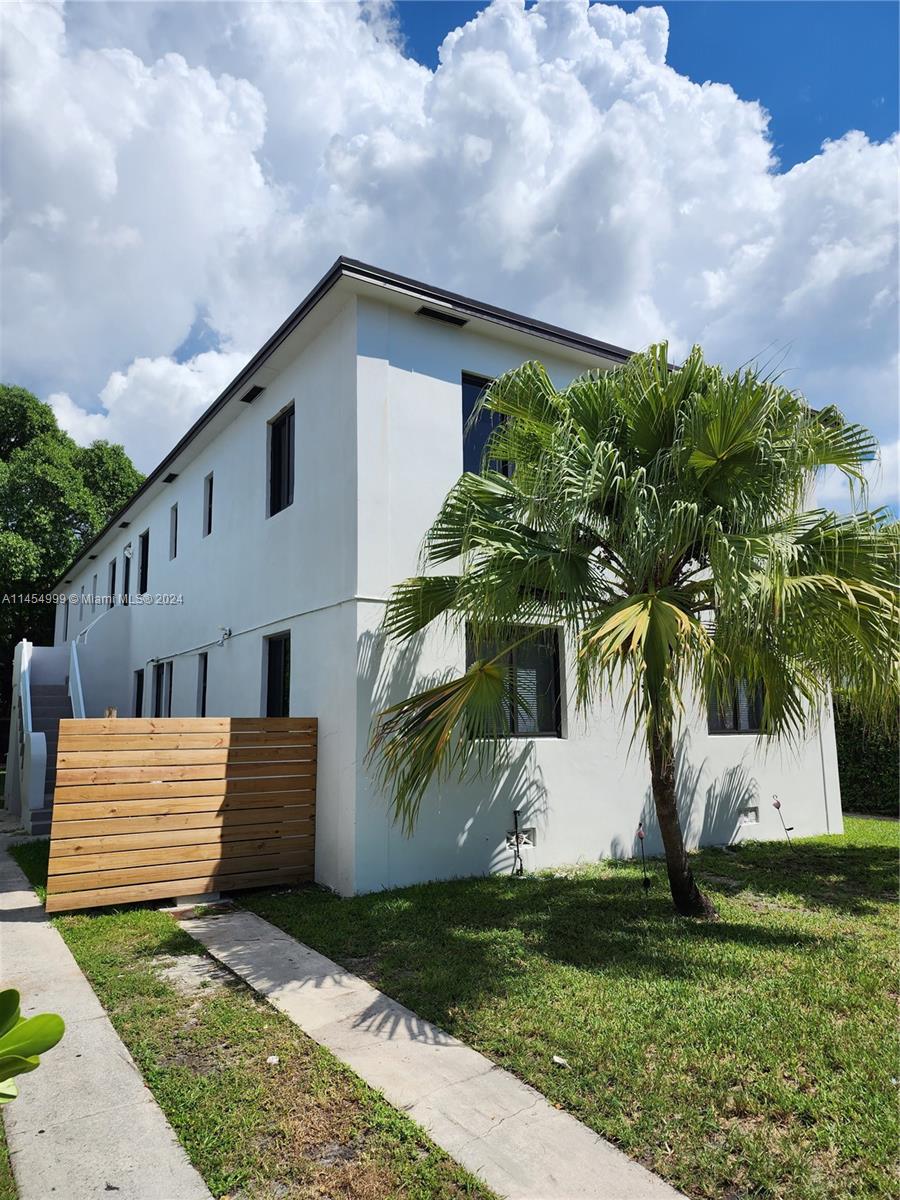 2141 Southwest 14th Terrace Miami, FL 33145 - Photo 31 of 47 a view of a white house with a yard and plants