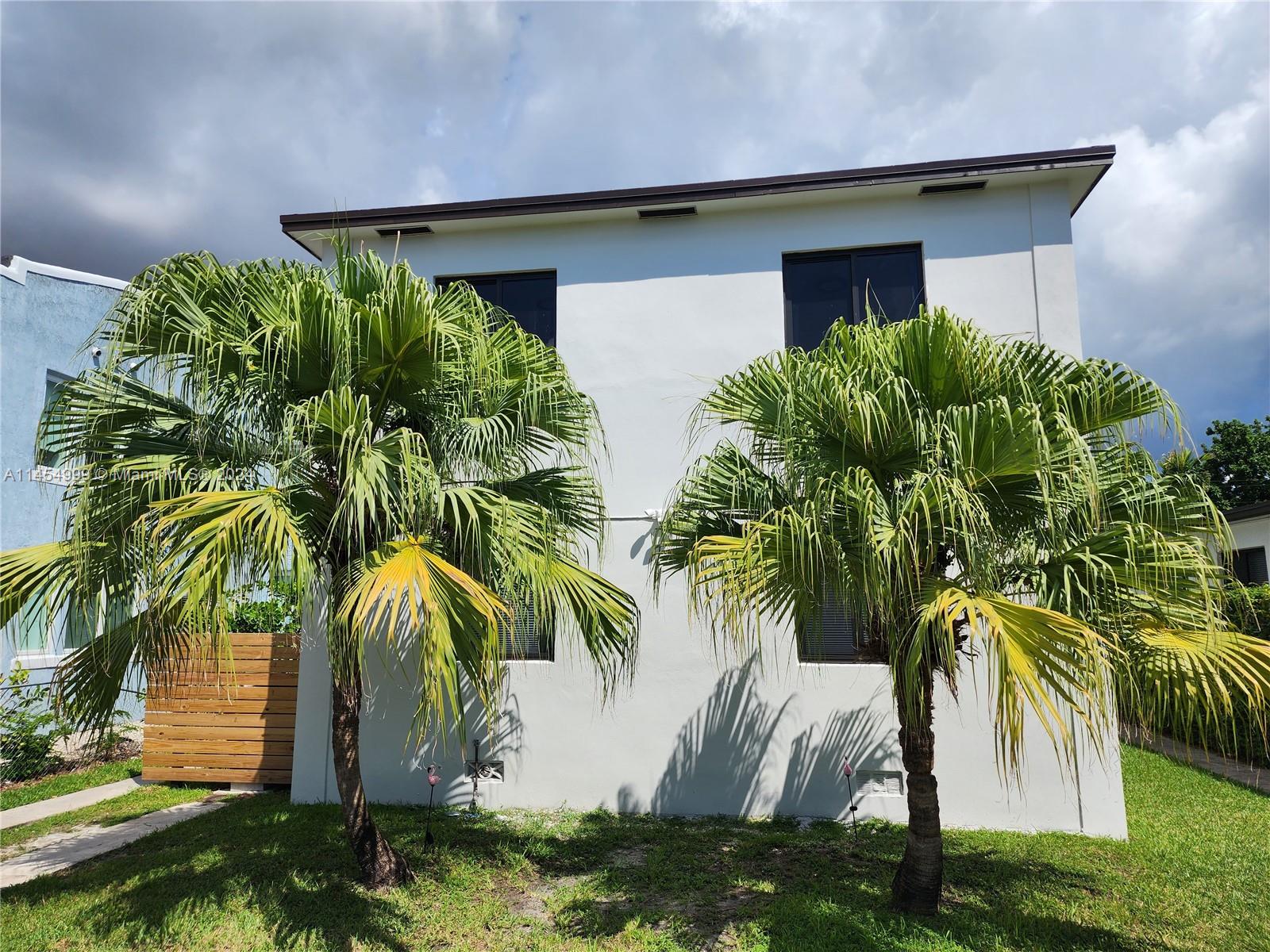 2141 Southwest 14th Terrace Miami, FL 33145 - Photo 36 of 47 a couple of palm trees in front of yellow house
