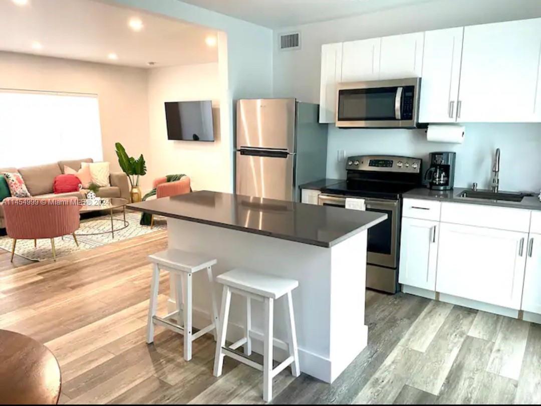 2141 Southwest 14th Terrace Miami, FL 33145 - Photo 6 of 47 a kitchen with stainless steel appliances a stove a sink refrigerator and microwave