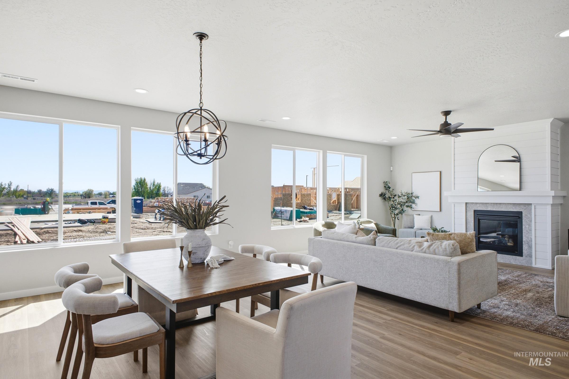 1645 Dyer Street Middleton, ID 83644 - Photo 12 of 31 Dining space with light wood-style floors, a glass covered fireplace, a ceiling fan, and recessed lighting