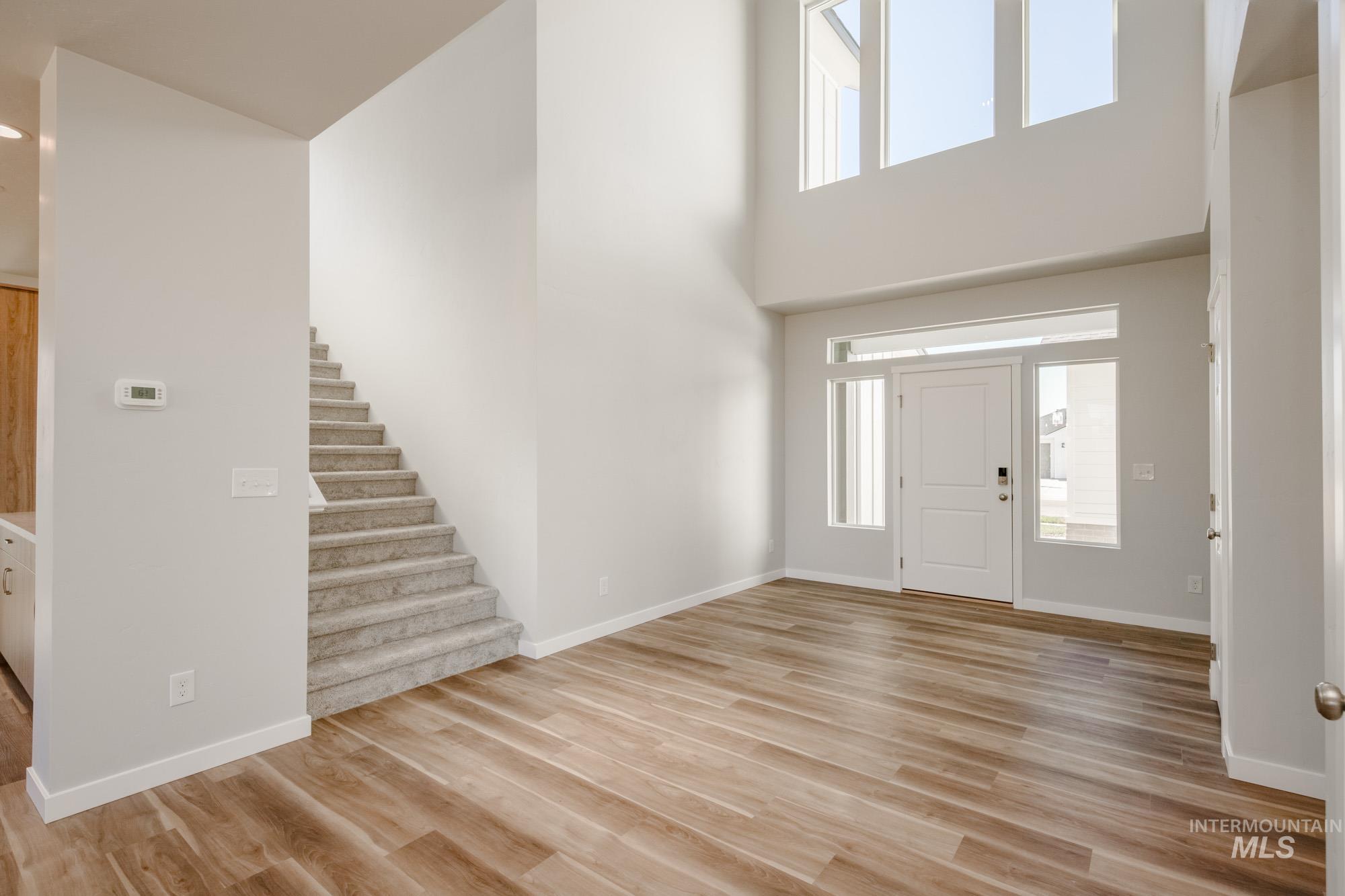 1645 Dyer Street Middleton, ID 83644 - Photo 15 of 32 Foyer featuring light wood-style floors, stairway, and a high ceiling