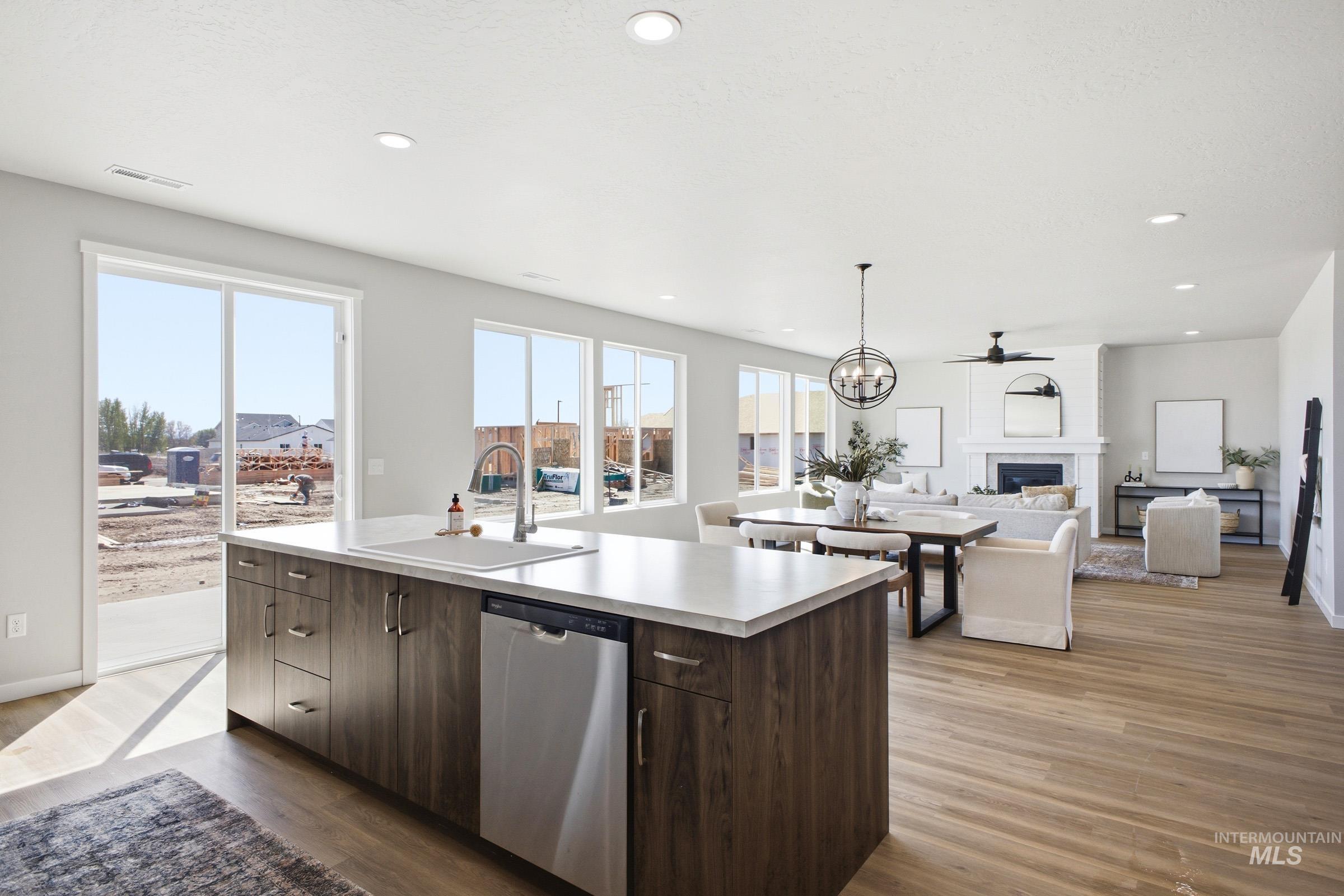 1645 Dyer Street Middleton, ID 83644 - Photo 31 of 31 Kitchen featuring dark wood finish cabinetry, open floor plan, light countertops, stainless steel dishwasher, and dark wood finished floors