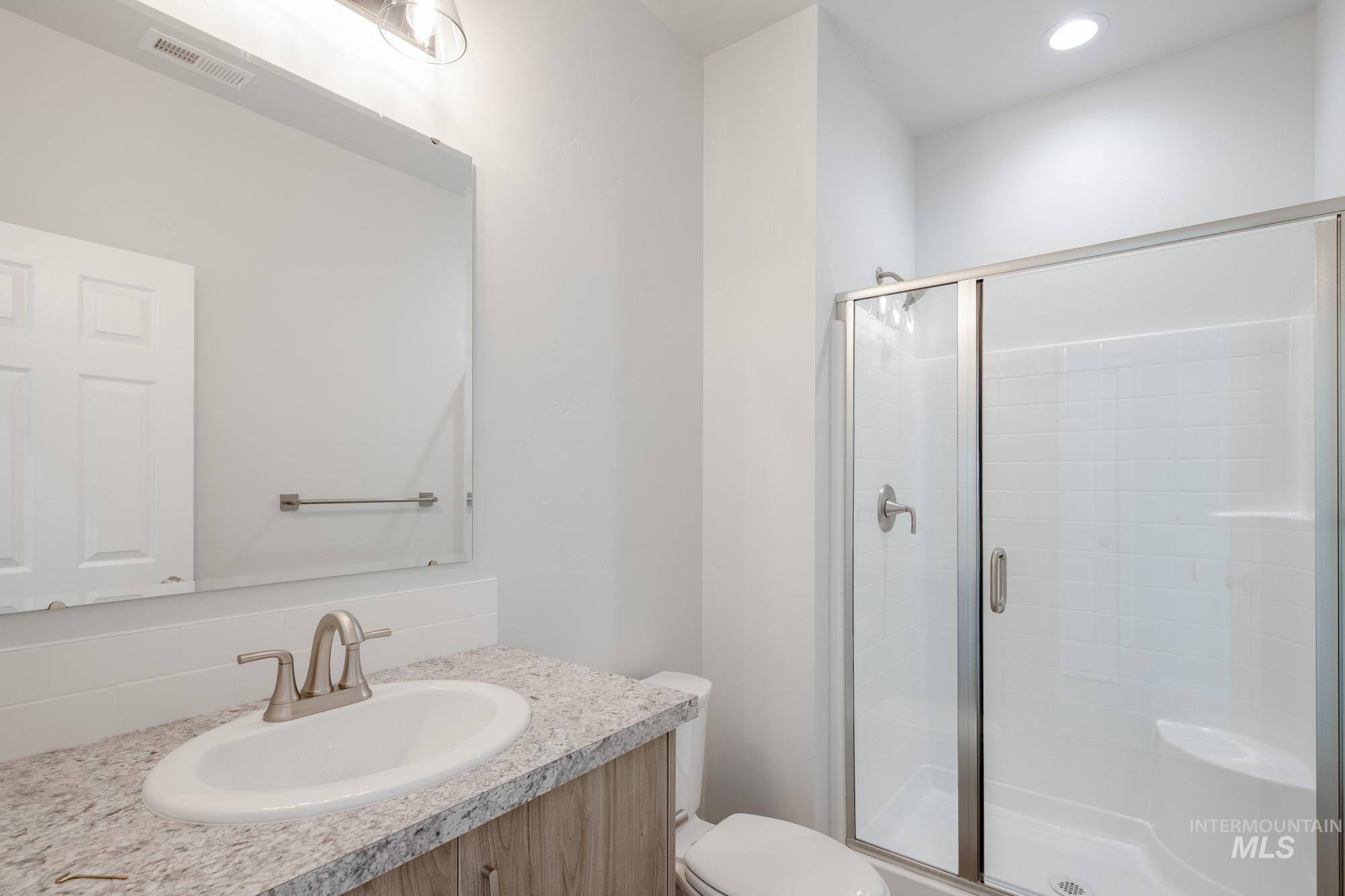 1645 Dyer Street Middleton, ID 83644 - Photo 22 of 32 Bathroom featuring a shower stall, vanity, backsplash, and recessed lighting