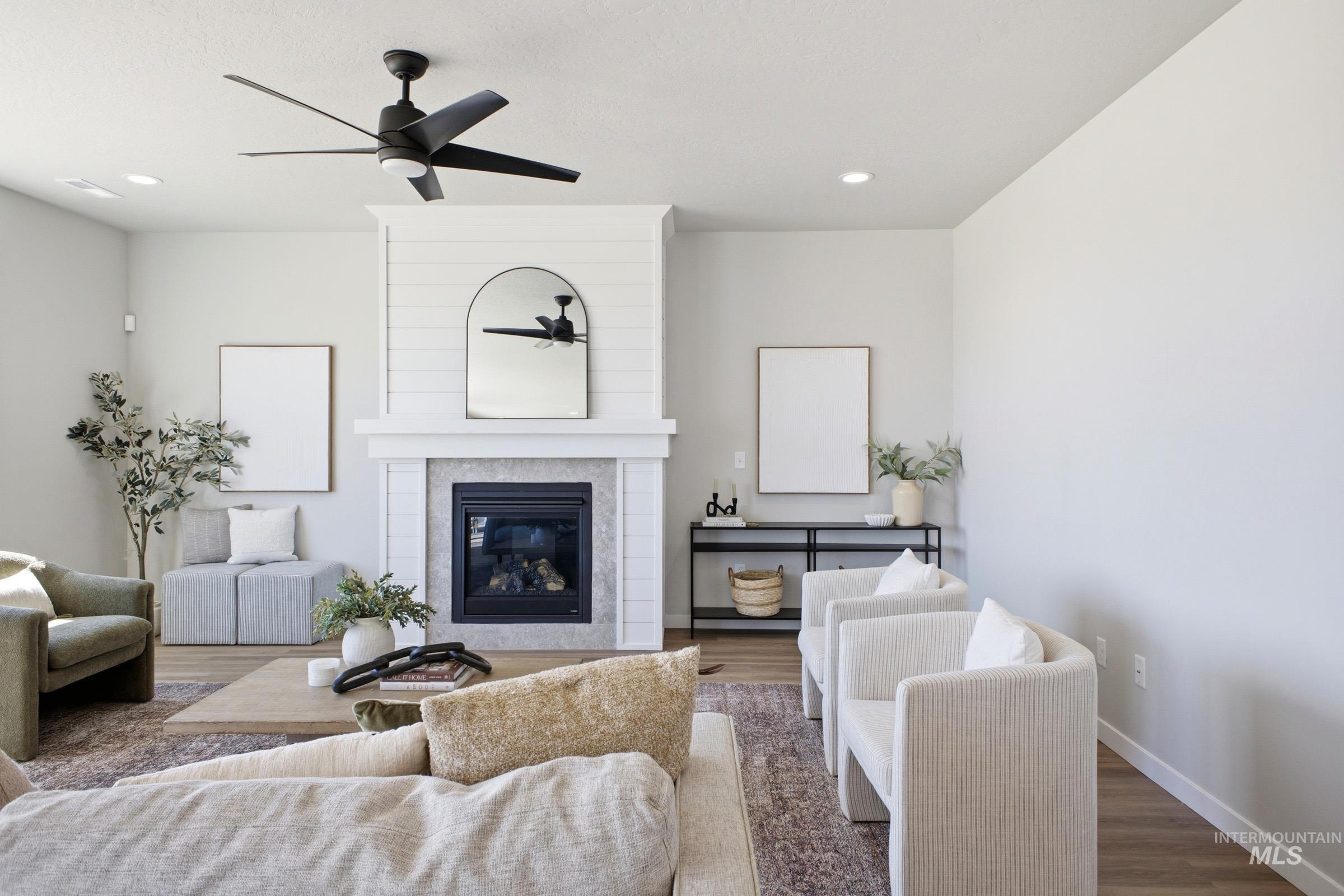1645 Dyer Street Middleton, ID 83644 - Photo 6 of 31 Living area featuring a fireplace, wood finished floors, recessed lighting, and a ceiling fan
