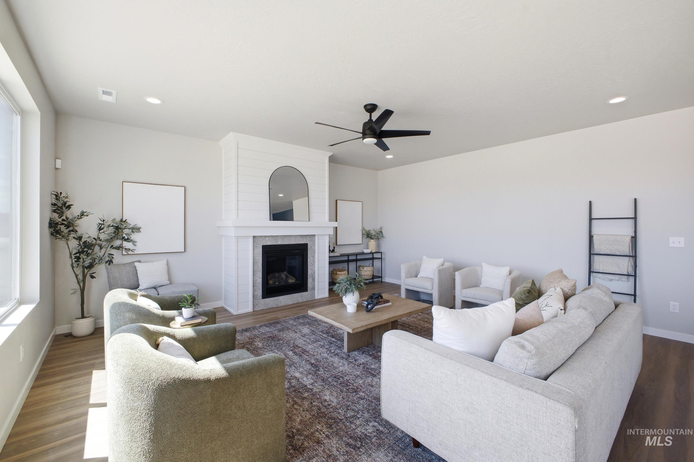 1645 Dyer Street Middleton, ID 83644 - Photo 7 of 31 Living room with a fireplace, wood finished floors, and ceiling fan