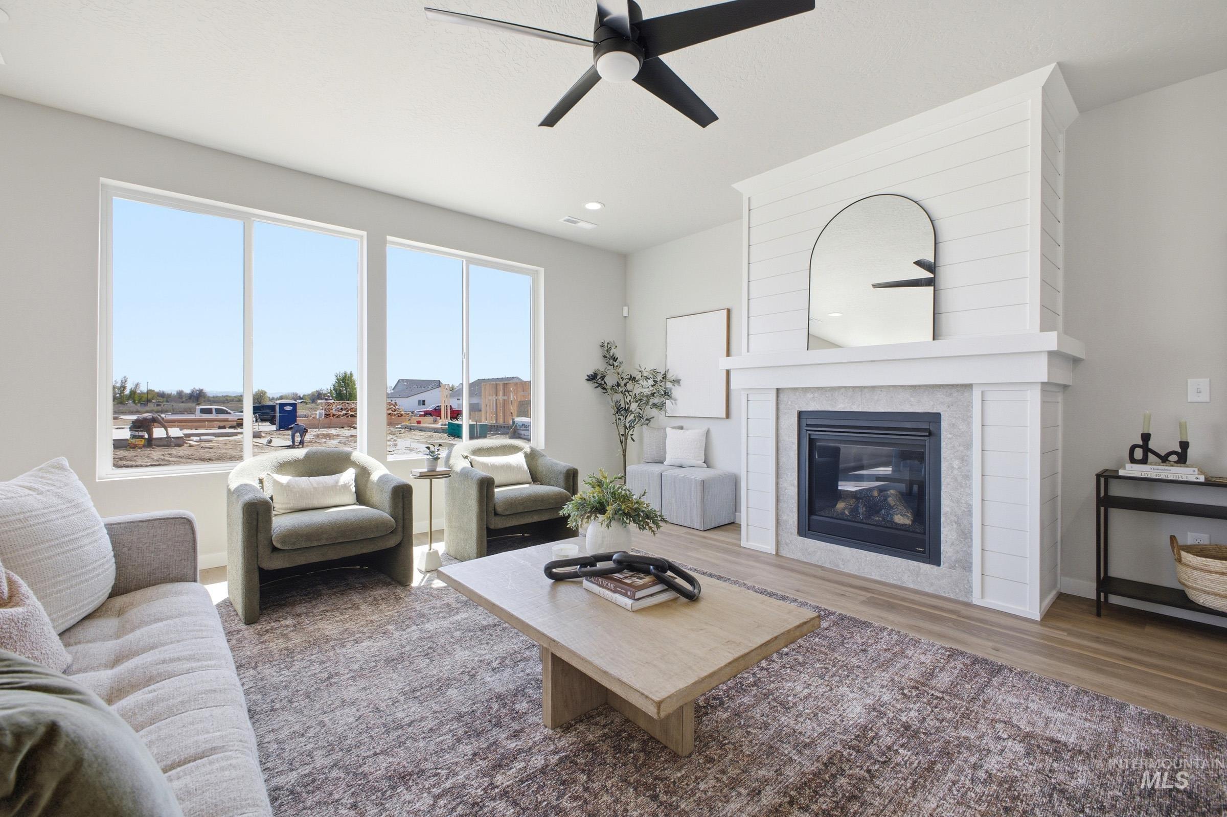 1645 Dyer Street Middleton, ID 83644 - Photo 8 of 31 Living room featuring dark wood-type flooring, a tile fireplace, and ceiling fan
