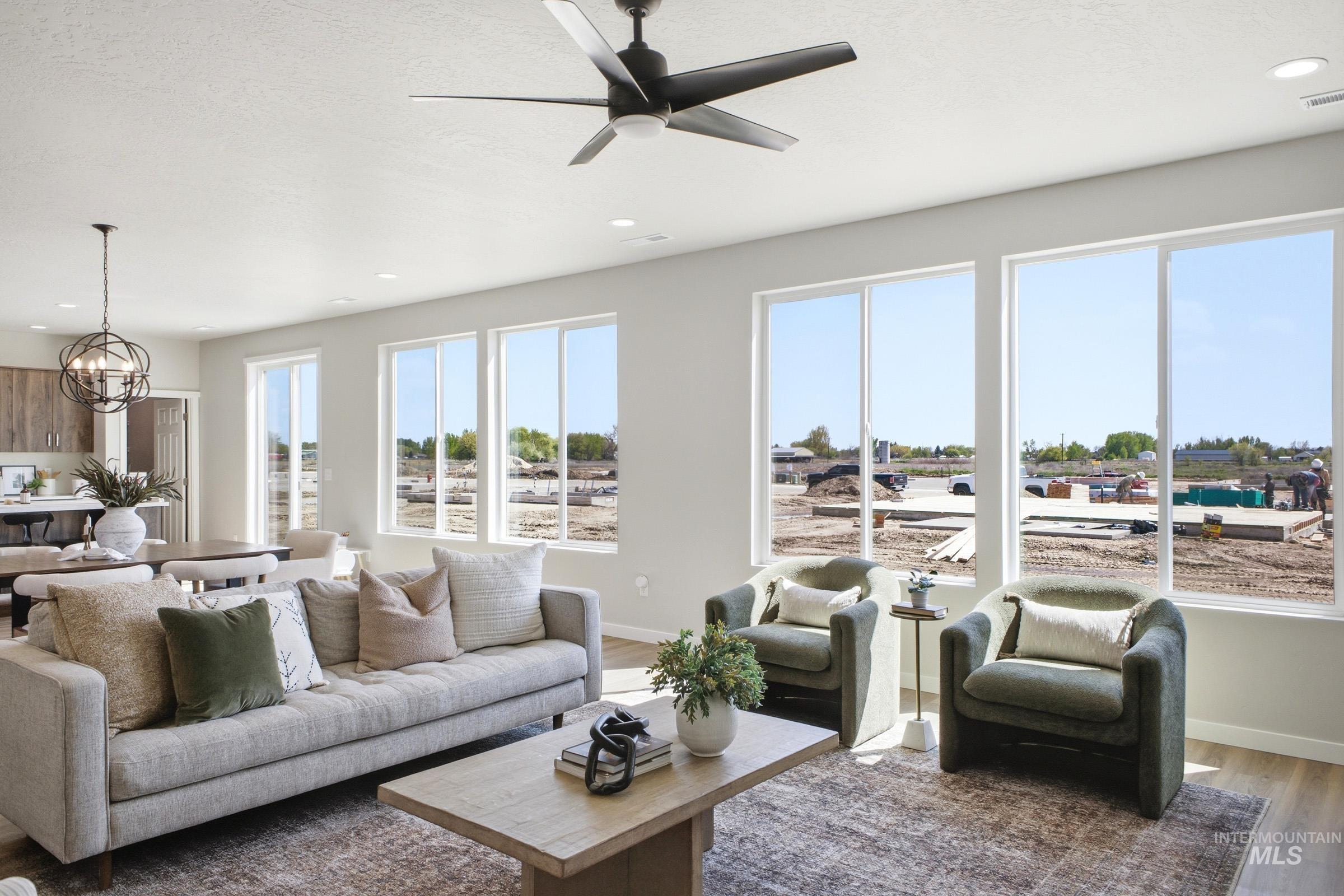 1645 Dyer Street Middleton, ID 83644 - Photo 10 of 31 Living room featuring suspended lighting, ceiling fan, and dark wood-type flooring