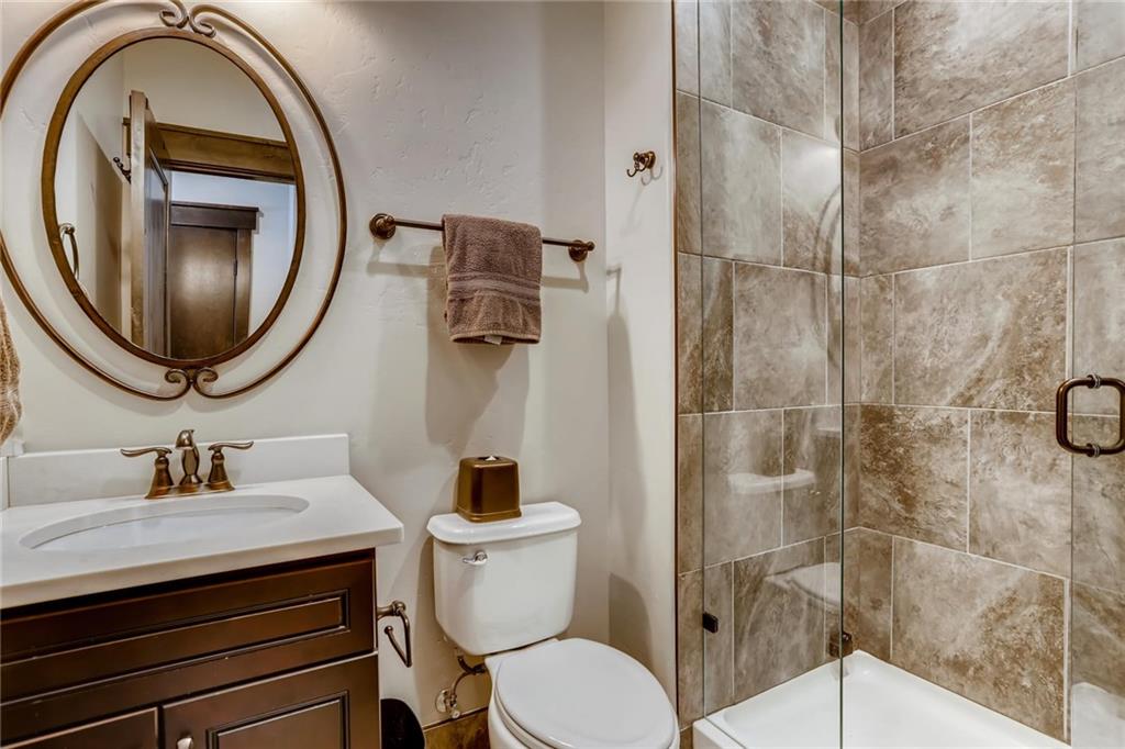 851 Independence Road, Unit 5A Keystone, CO 80435 - Photo 15 of 28 a bathroom with a toilet sink and mirror