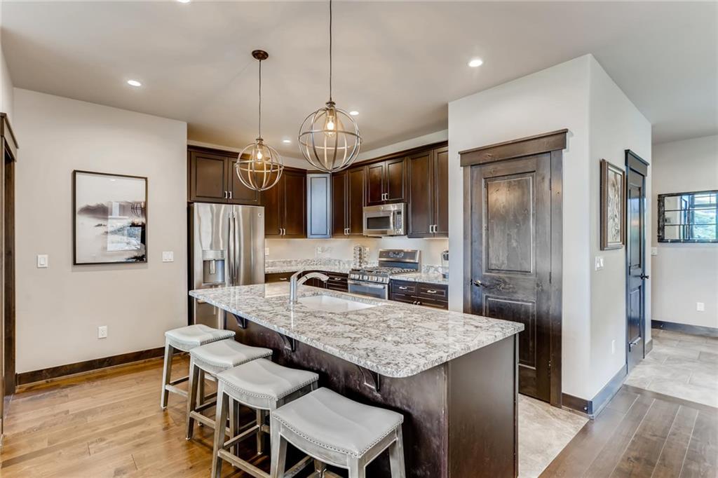 851 Independence Road, Unit 5A Keystone, CO 80435 - Photo 9 of 28 a kitchen with granite countertop kitchen island and stainless steel appliances