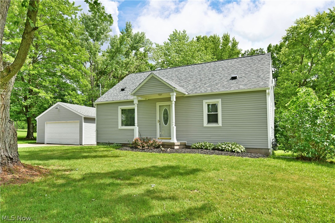 View of front of house featuring a garage and a front yard