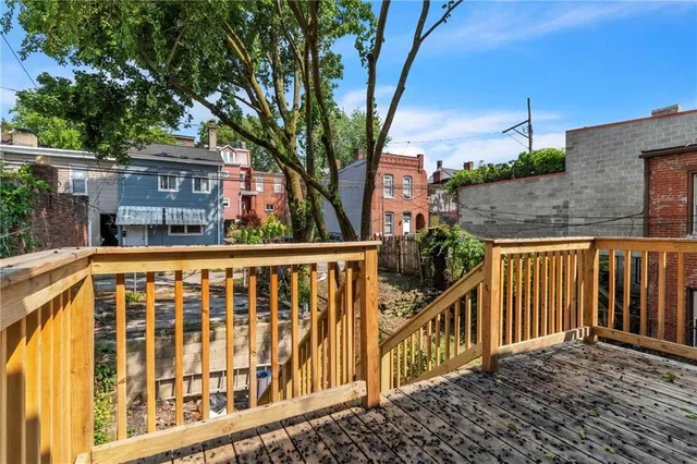 a view of a brick house with a small yard