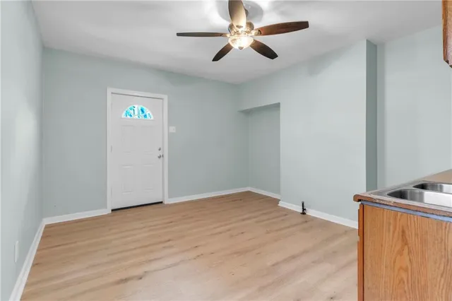 a view of empty room with ceiling fan