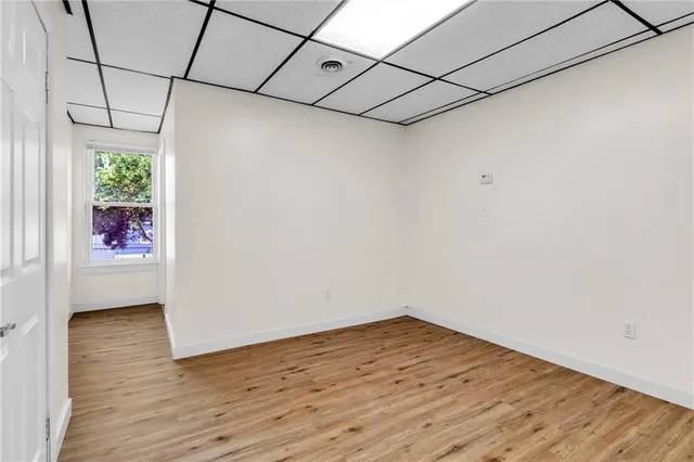 a view of a room with wooden floor