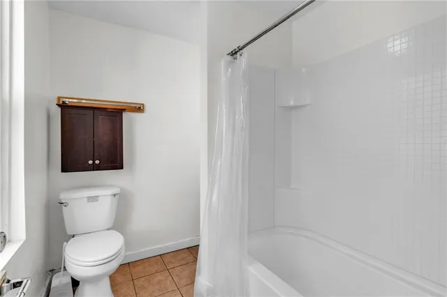 a bathroom with a toilet and a bathtub