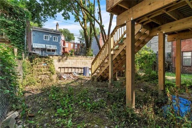 a view of a house with a tree in the yard