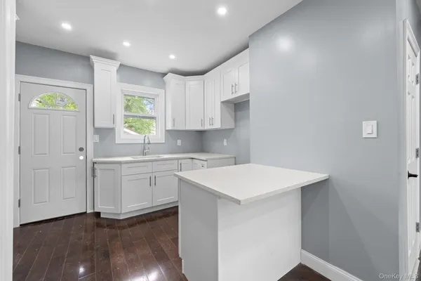 a kitchen with a sink cabinets and window