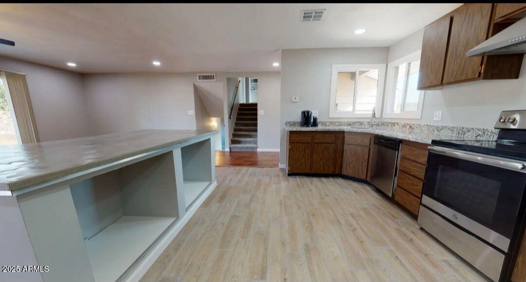 4216 West Solano Drive Phoenix, AZ 85019 - Photo 5 of 13 a large kitchen with granite countertop a stove and a sink