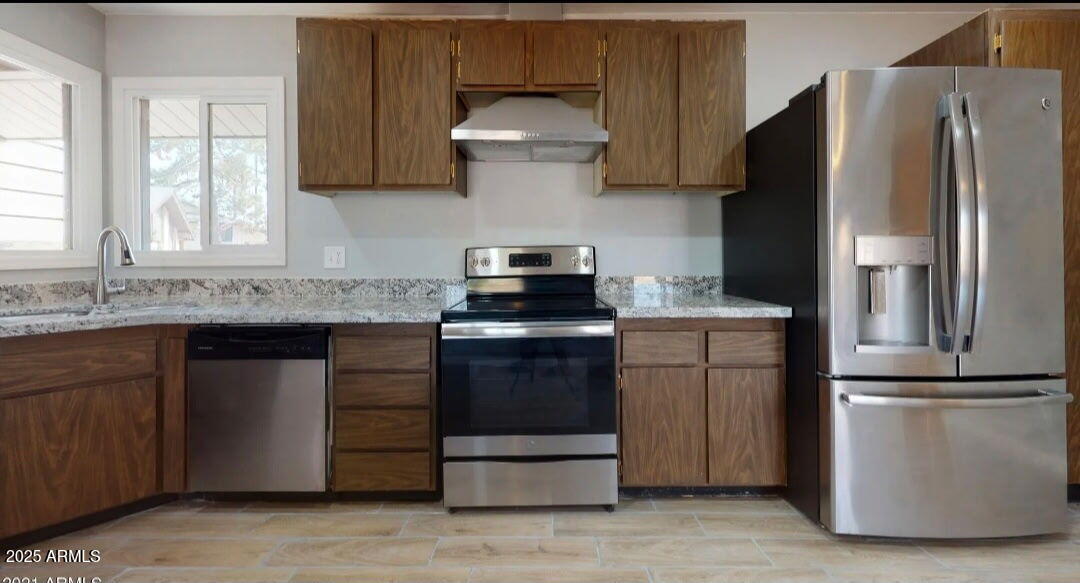 4216 West Solano Drive Phoenix, AZ 85019 - Photo 6 of 13 a kitchen with a refrigerator sink and cabinets