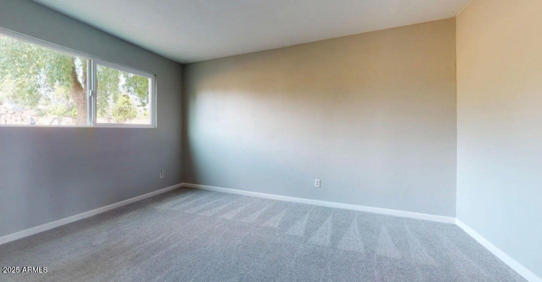 4216 West Solano Drive Phoenix, AZ 85019 - Photo 8 of 13 an empty room with a window