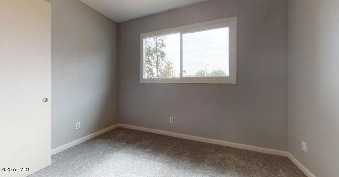 4216 West Solano Drive Phoenix, AZ 85019 - Photo 10 of 13 an empty room with a window