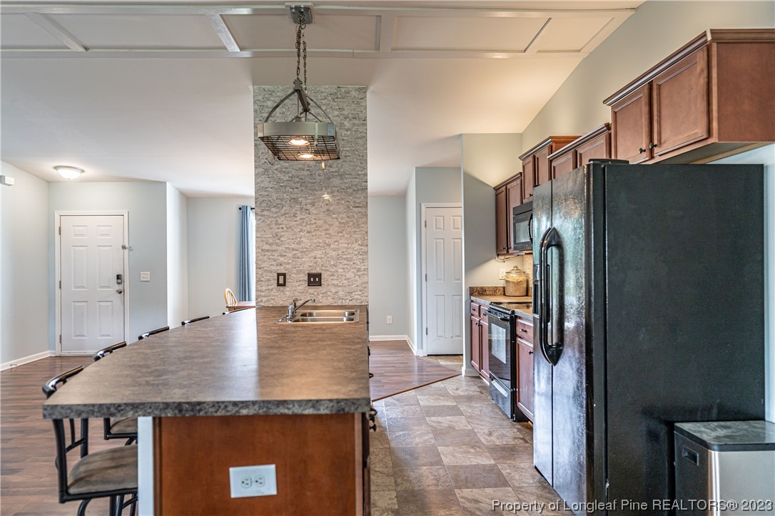 20 Old English Lane Spring Lake, NC 28390 - Photo 14 of 41 a kitchen with stainless steel appliances granite countertop a refrigerator a stove and a sink