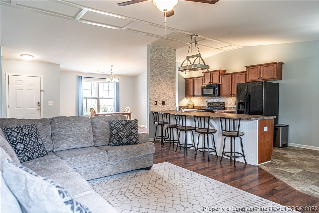 20 Old English Lane Spring Lake, NC 28390 - Photo 19 of 41 a living room with furniture a flat screen tv and kitchen view