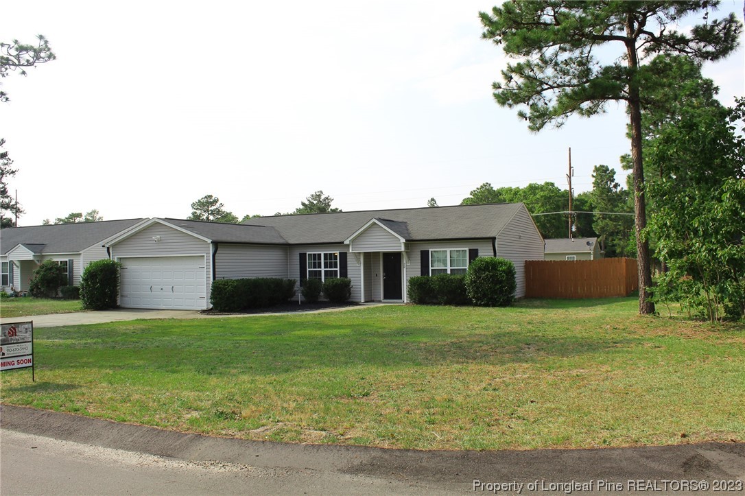 20 Old English Lane Spring Lake, NC 28390 - Photo 2 of 41 a front view of a house with a yard and trees