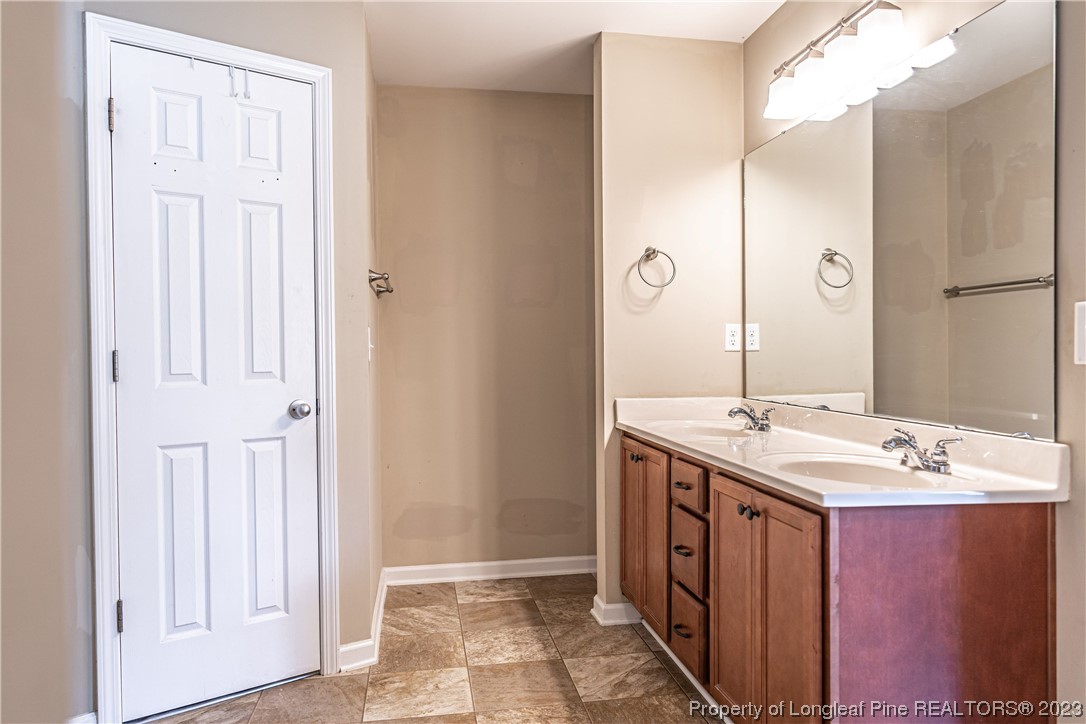 20 Old English Lane Spring Lake, NC 28390 - Photo 27 of 41 a spacious bathroom with a mirror a sink and shower