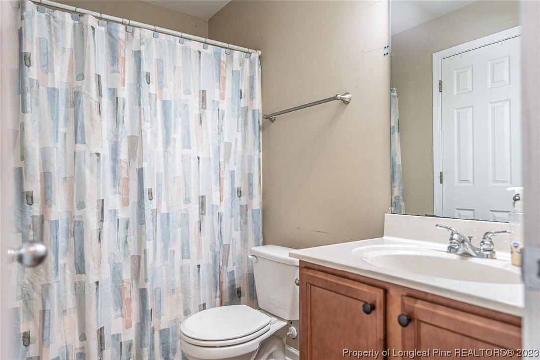 20 Old English Lane Spring Lake, NC 28390 - Photo 31 of 41 a bathroom with a sink a toilet and shower curtain