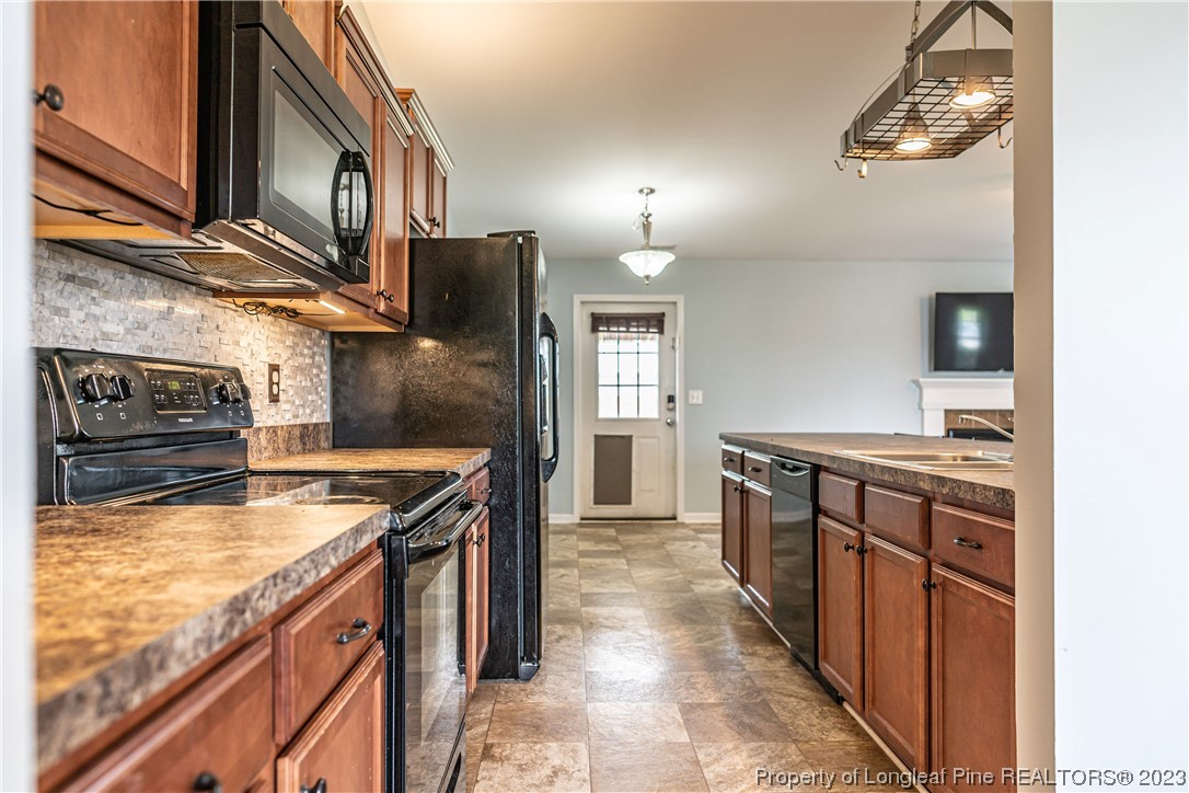 20 Old English Lane Spring Lake, NC 28390 - Photo 9 of 41 a kitchen with stainless steel appliances granite countertop a stove and a sink