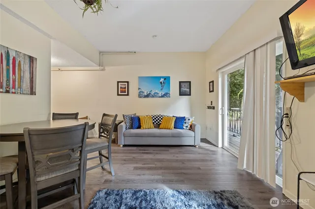 a living room with furniture a flat screen tv and a table