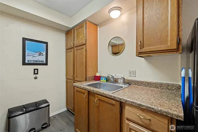a bathroom with a granite countertop sink and a mirror