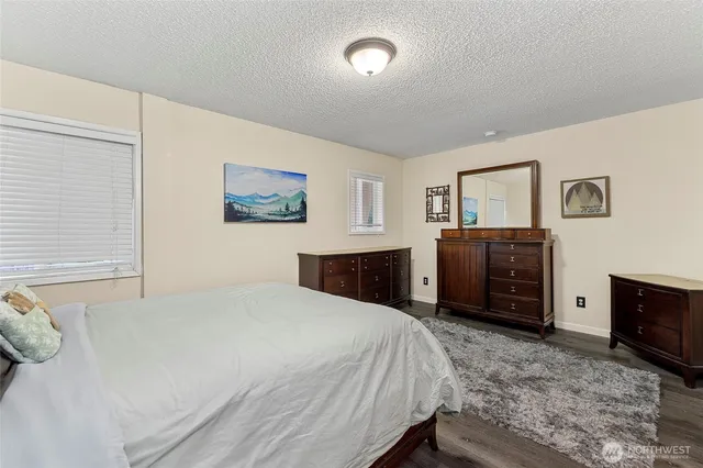 a bedroom with a bed and a television