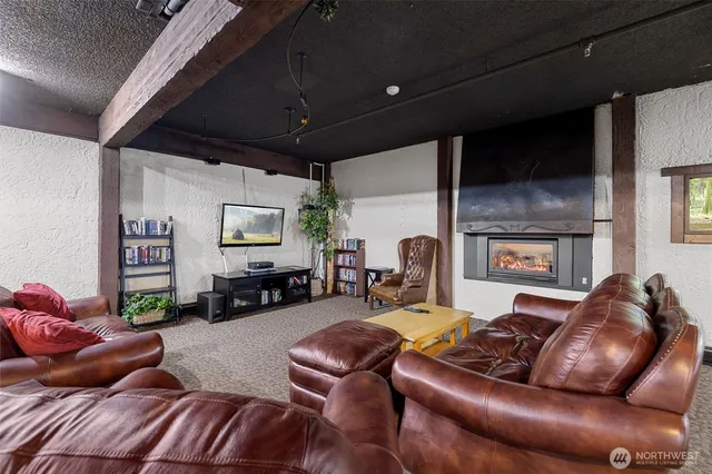 a living room with furniture a fireplace and a flat screen tv