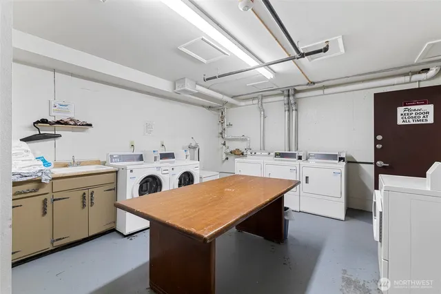 a utility room with sink dryer and washer