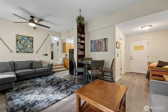 a living room with furniture rug and wooden floor